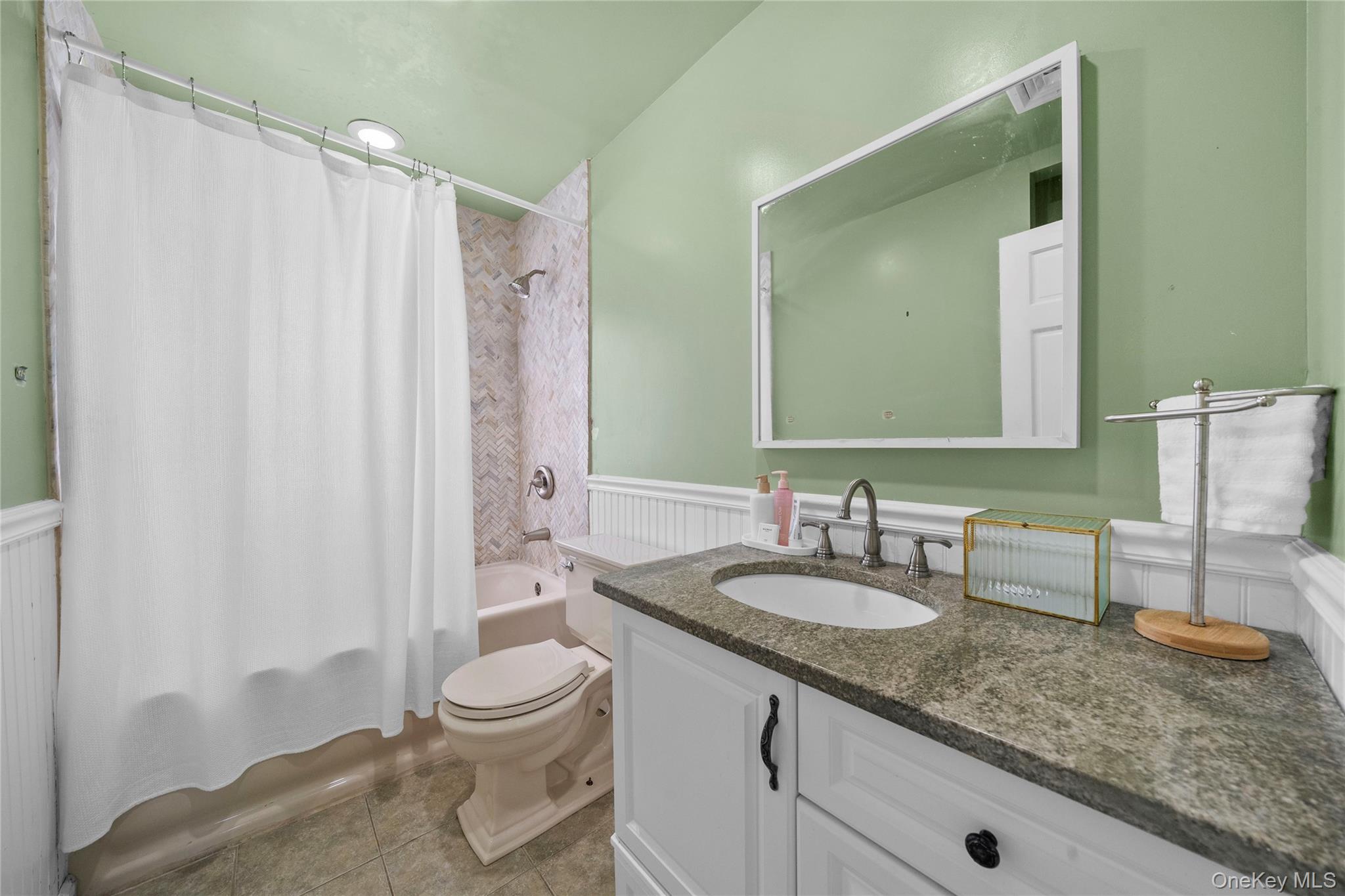 Undisclosed Address Freeport, NY 11520 - Photo 17 of 22 a bathroom with a granite countertop sink a toilet and a mirror