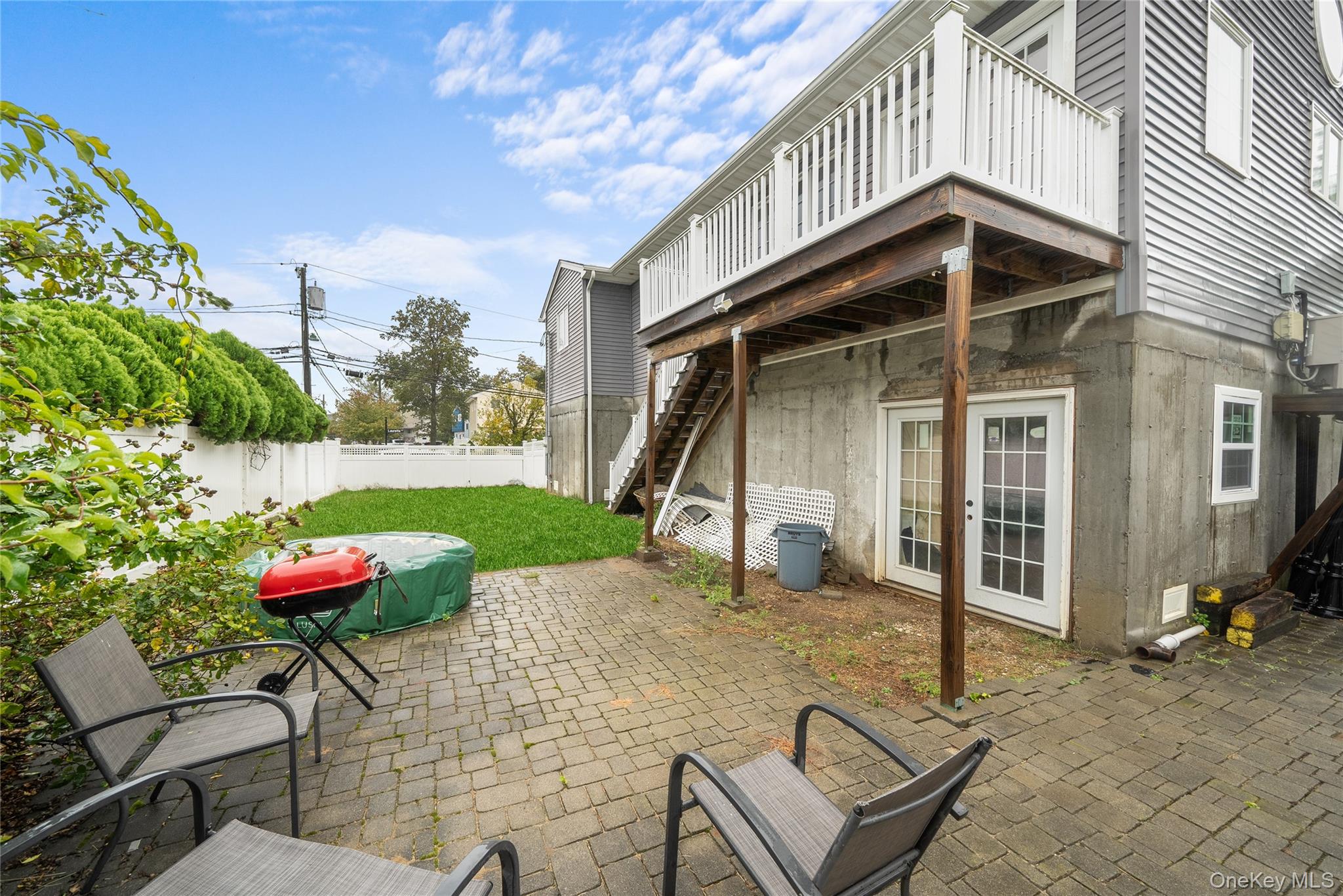 Undisclosed Address Freeport, NY 11520 - Photo 20 of 22 a blue and white house with outdoor space