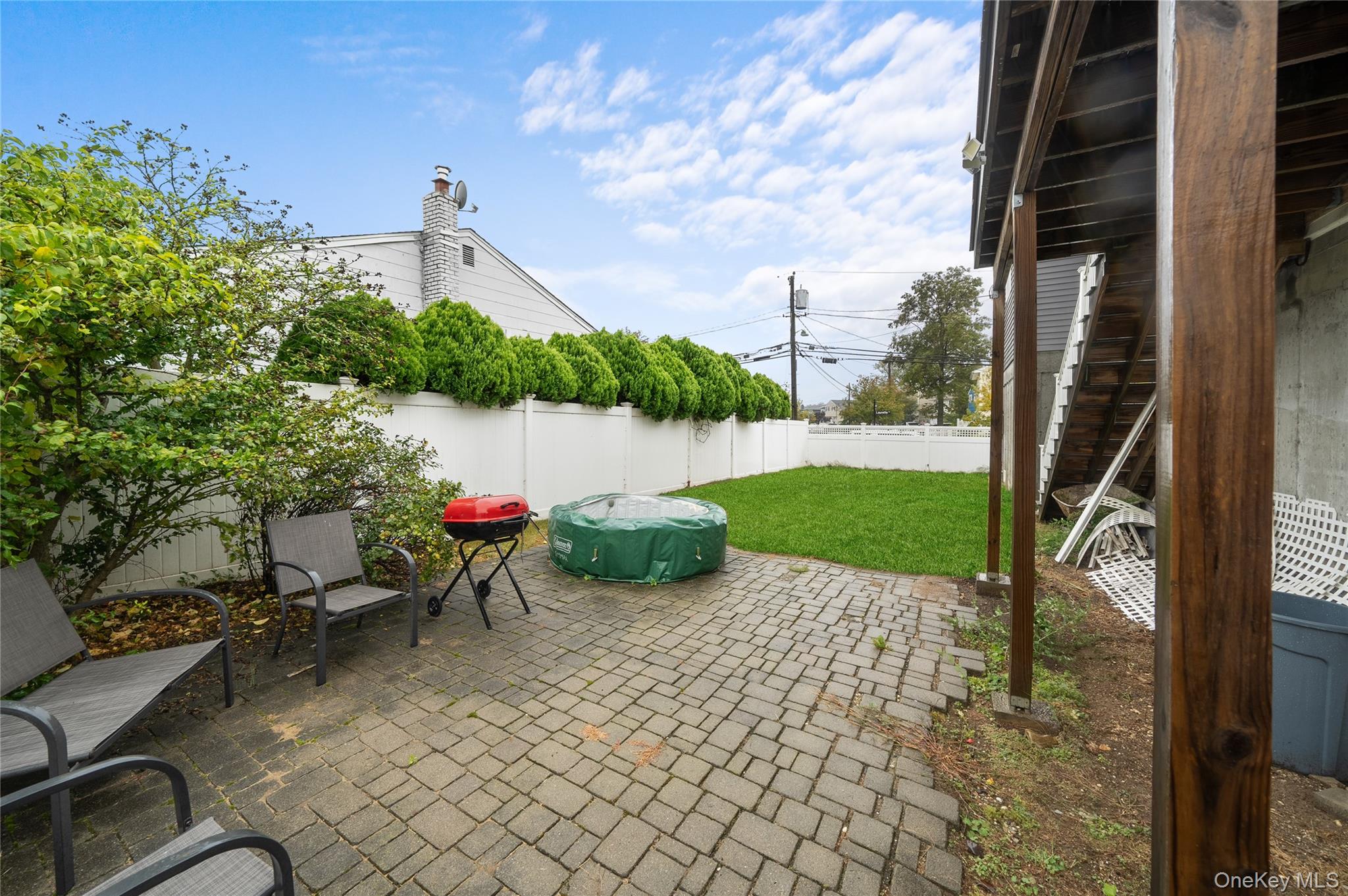 Undisclosed Address Freeport, NY 11520 - Photo 21 of 22 a view of a lake with a chair and table in the patio