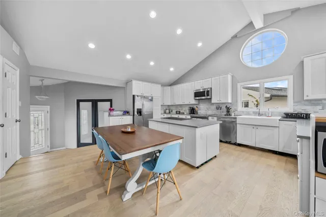 a kitchen with a sink cabinets and wooden floor