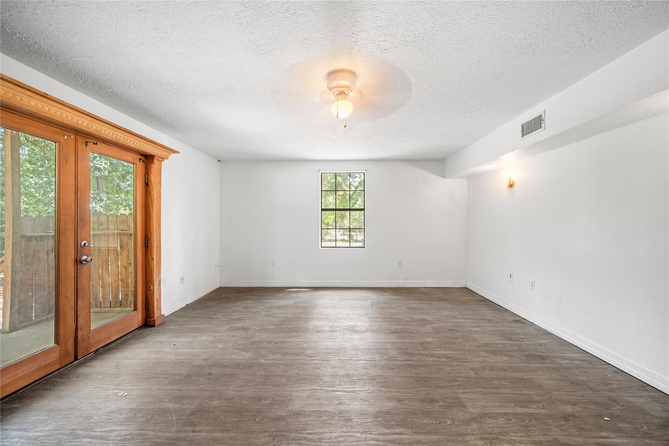 27607 Decker Woods Drive Magnolia, TX 77354 - Photo 15 of 48 an empty room with wooden floor and windows