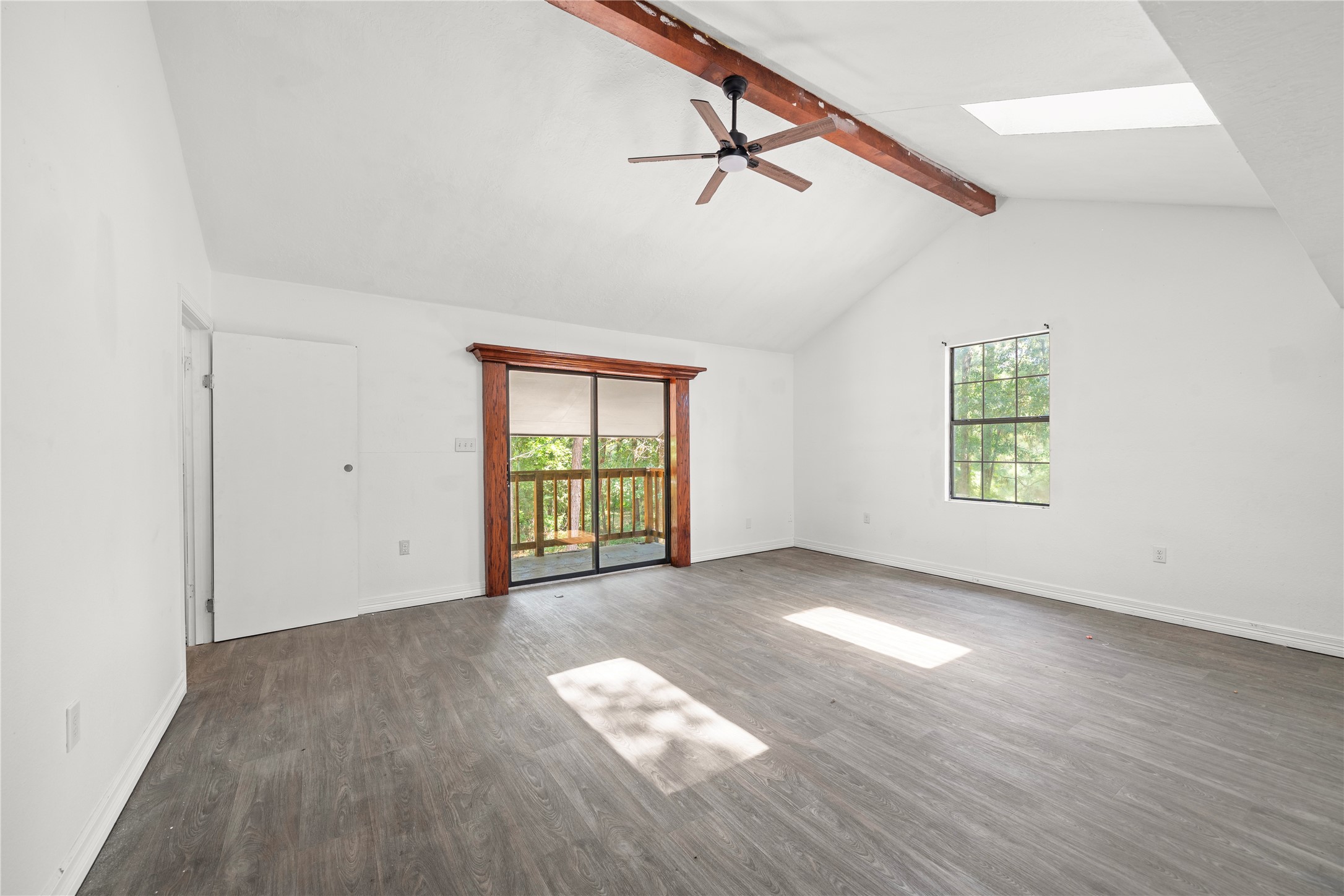 27607 Decker Woods Drive Magnolia, TX 77354 - Photo 21 of 48 an empty room with wooden floor chandelier and windows