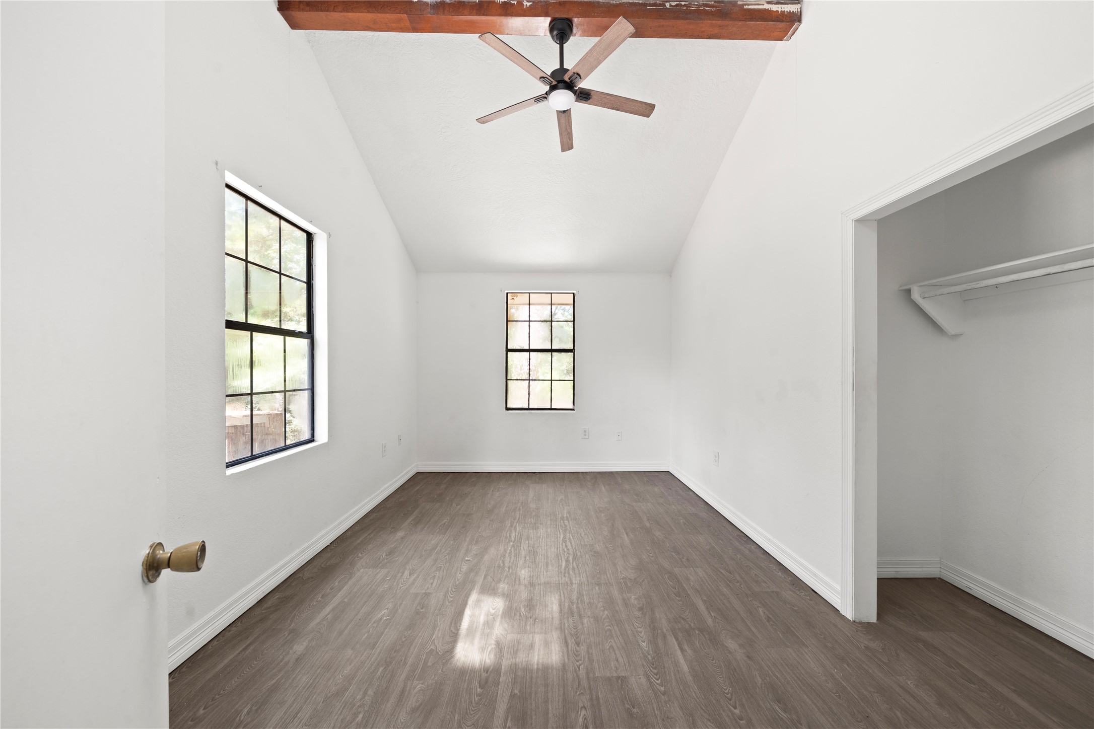 27607 Decker Woods Drive Magnolia, TX 77354 - Photo 28 of 48 an empty room with wooden floor ceiling fan and windows
