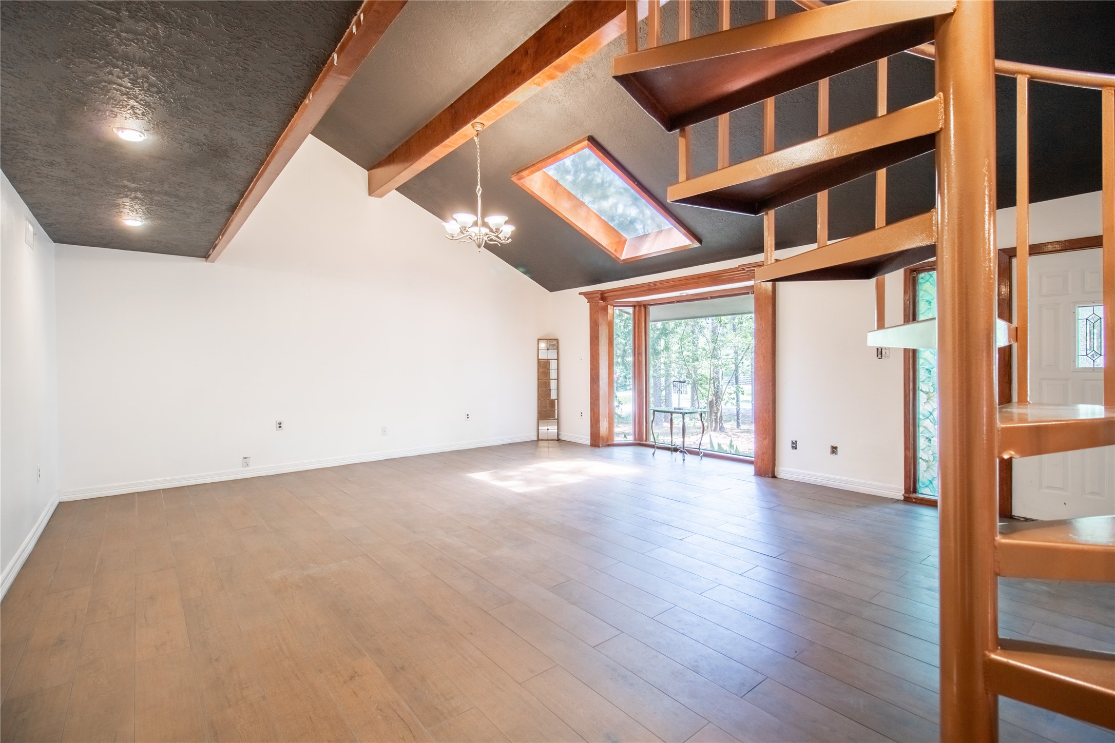 27607 Decker Woods Drive Magnolia, TX 77354 - Photo 4 of 48 a view of an empty room with wooden floor and a window