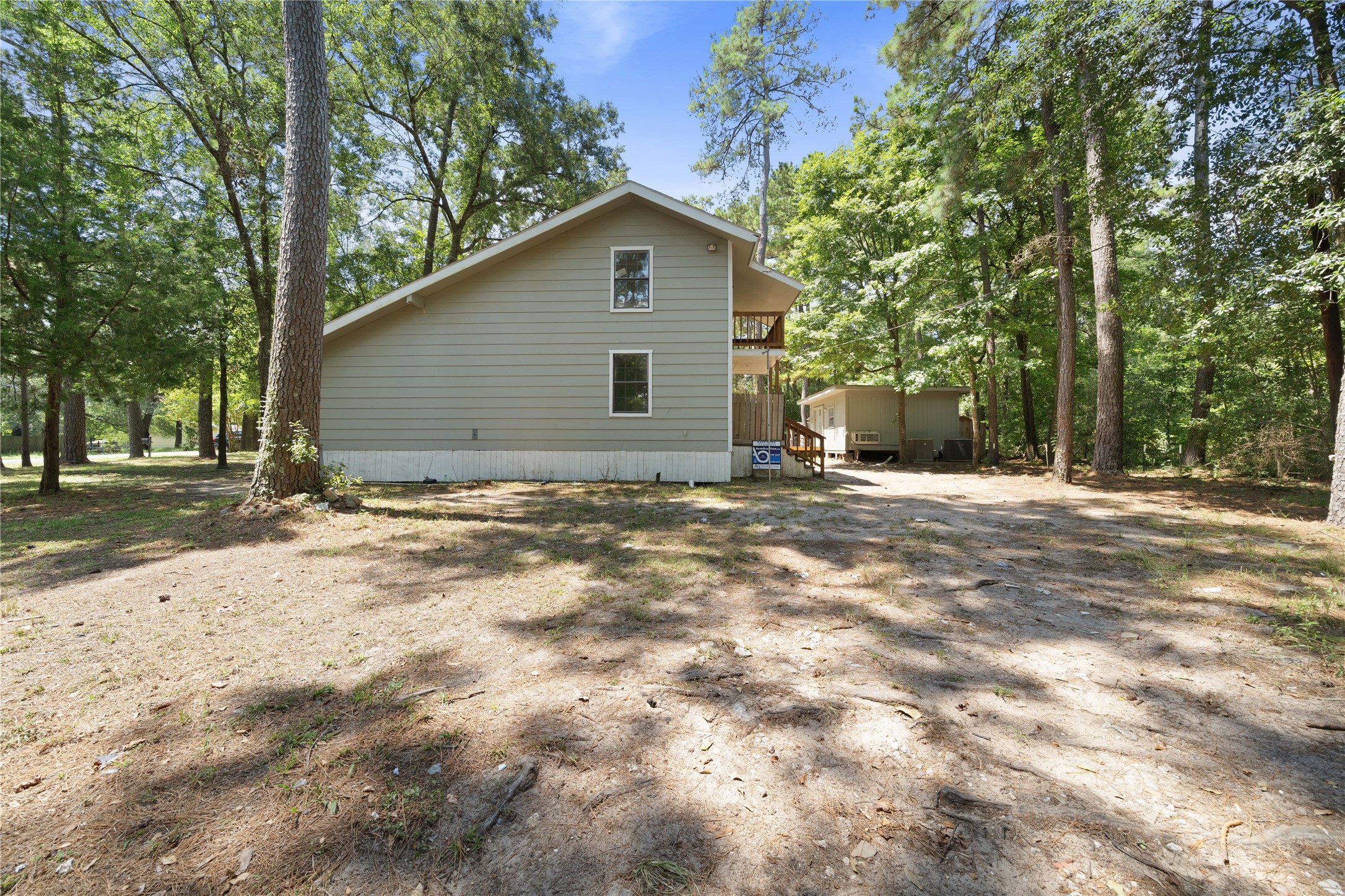 27607 Decker Woods Drive Magnolia, TX 77354 - Photo 43 of 48 a backyard of a house with large trees and brick walls
