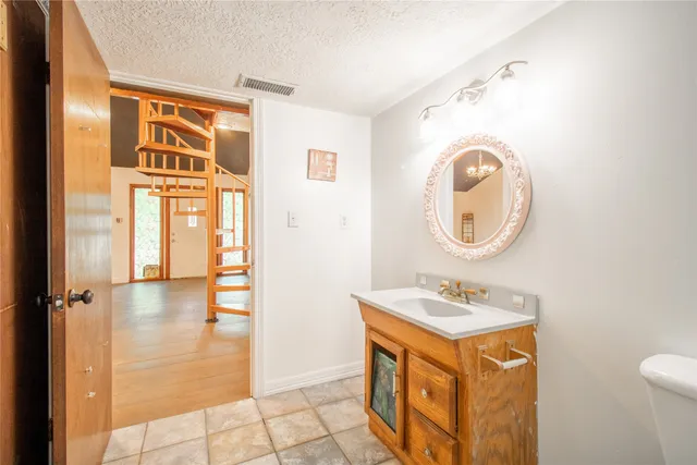 a bathroom with a sink a mirror and a shower