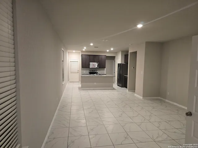 a view of a kitchen with a sink and a refrigerator