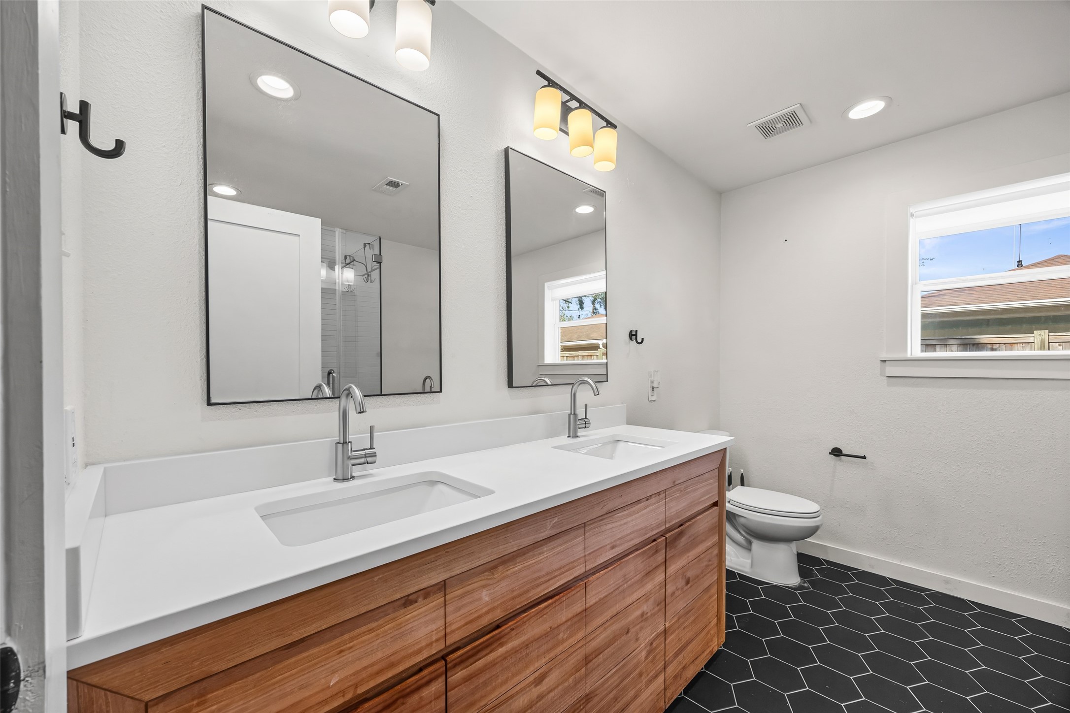 9715 Greenwillow Street Houston, TX 77096 - Photo 21 of 31 a bathroom with a sink and a mirror