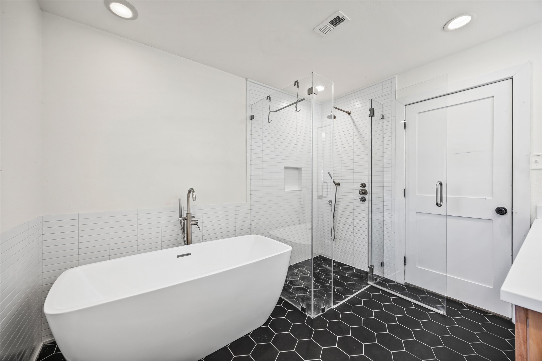 9715 Greenwillow Street Houston, TX 77096 - Photo 22 of 31 a bathroom with a bathtub and shower