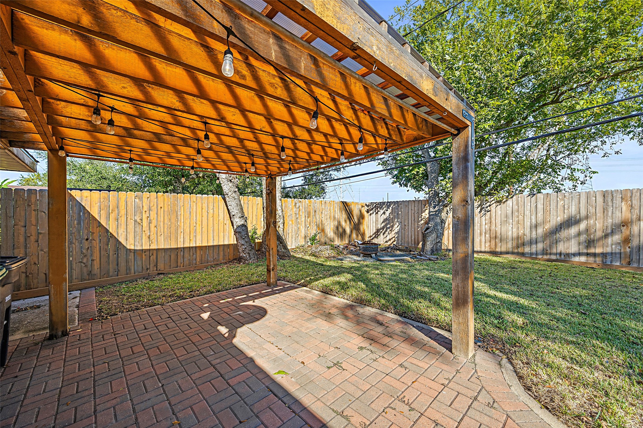 9715 Greenwillow Street Houston, TX 77096 - Photo 30 of 31 a backyard of a house with a yard and wooden fence