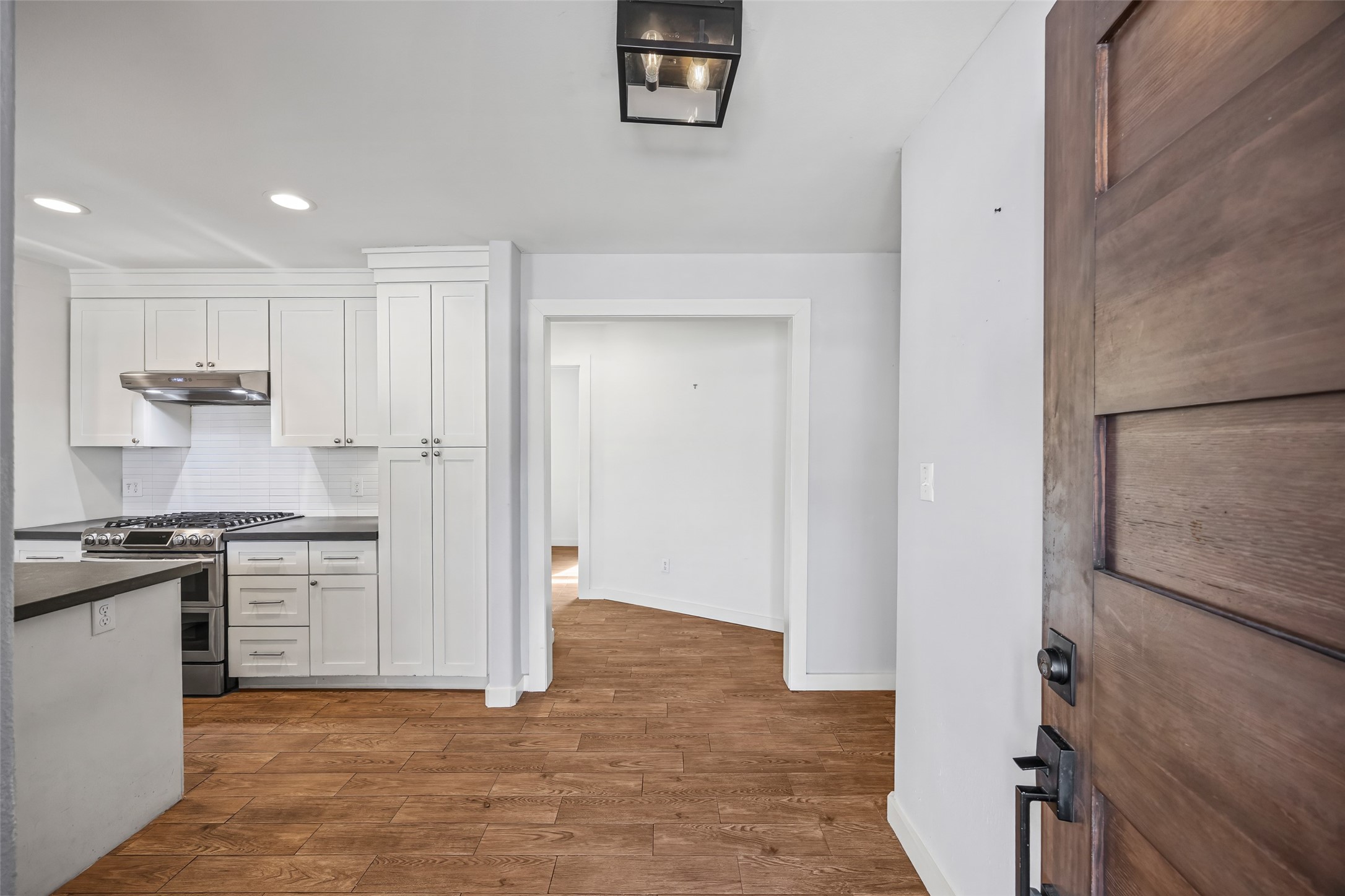 9715 Greenwillow Street Houston, TX 77096 - Photo 3 of 31 a kitchen with granite countertop a refrigerator stove and sink
