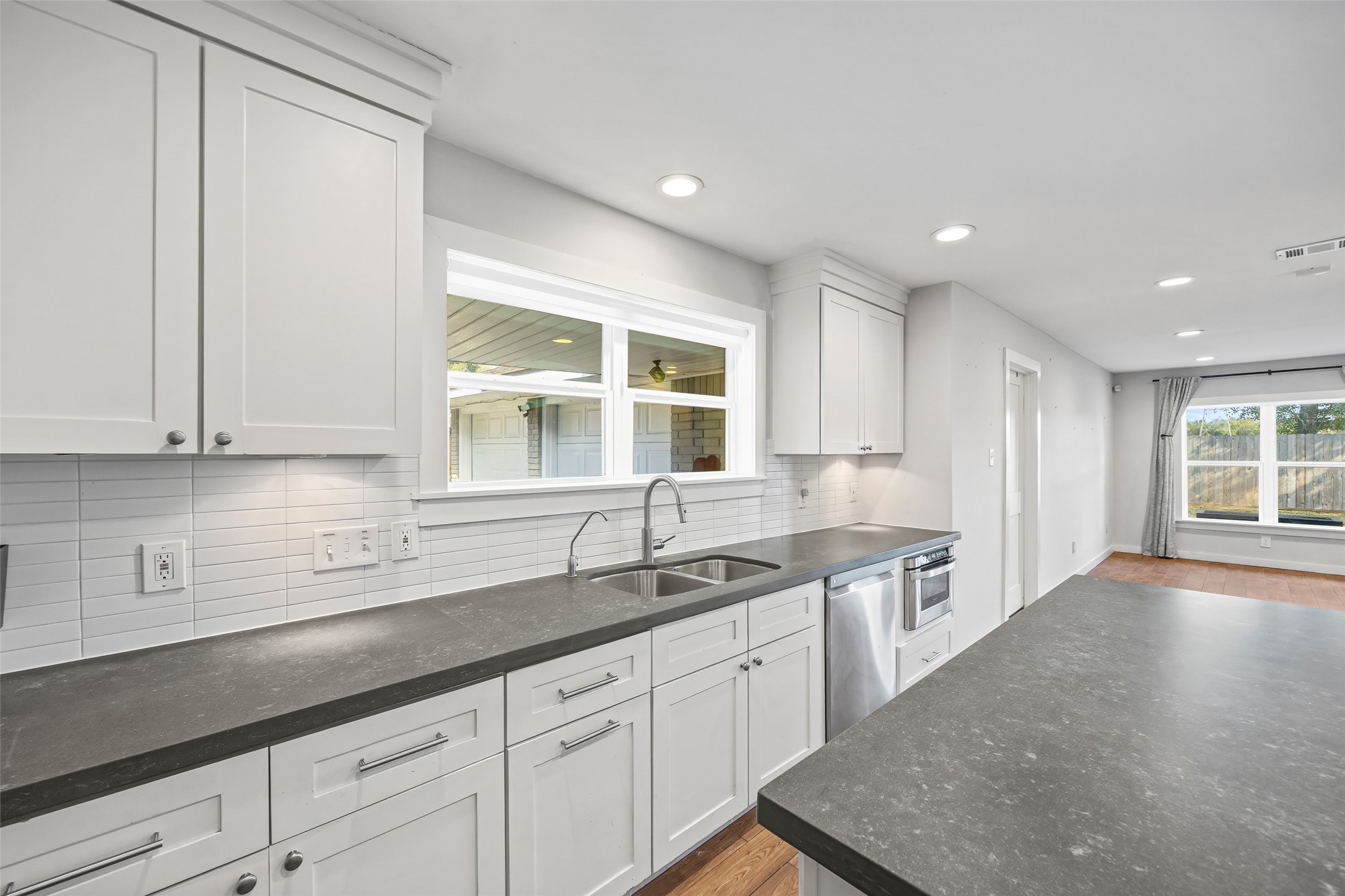 9715 Greenwillow Street Houston, TX 77096 - Photo 6 of 31 a kitchen with a sink and cabinets