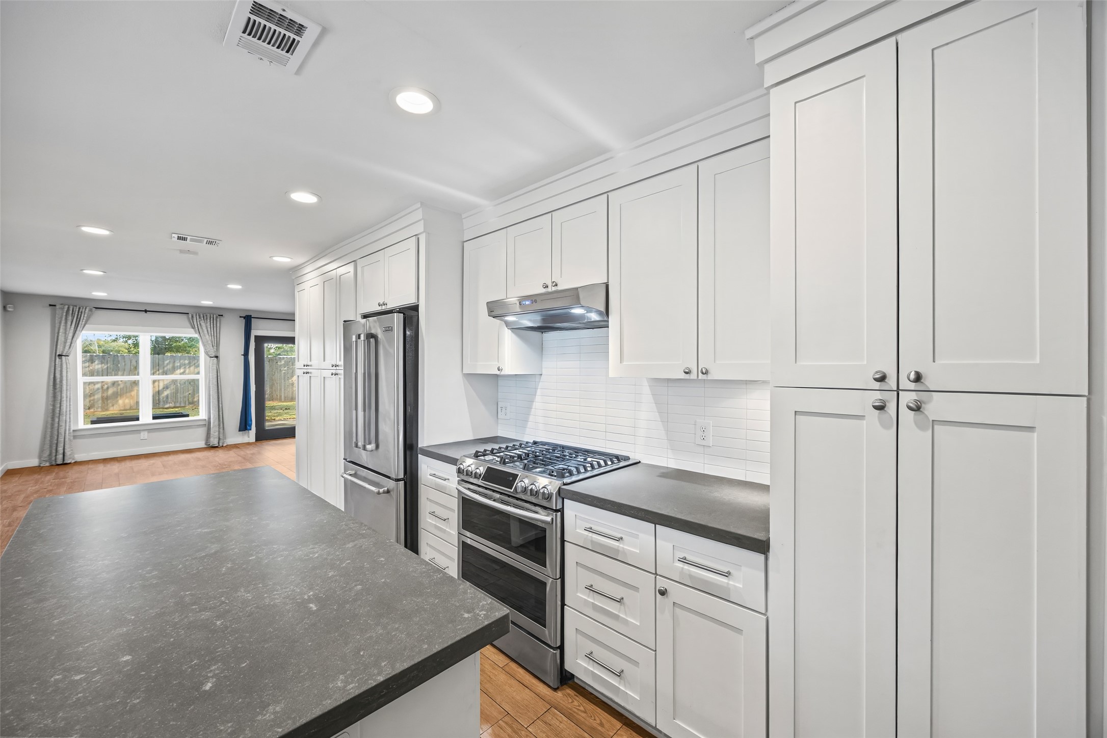 9715 Greenwillow Street Houston, TX 77096 - Photo 7 of 31 a kitchen with stainless steel appliances granite countertop a stove a sink and a refrigerator