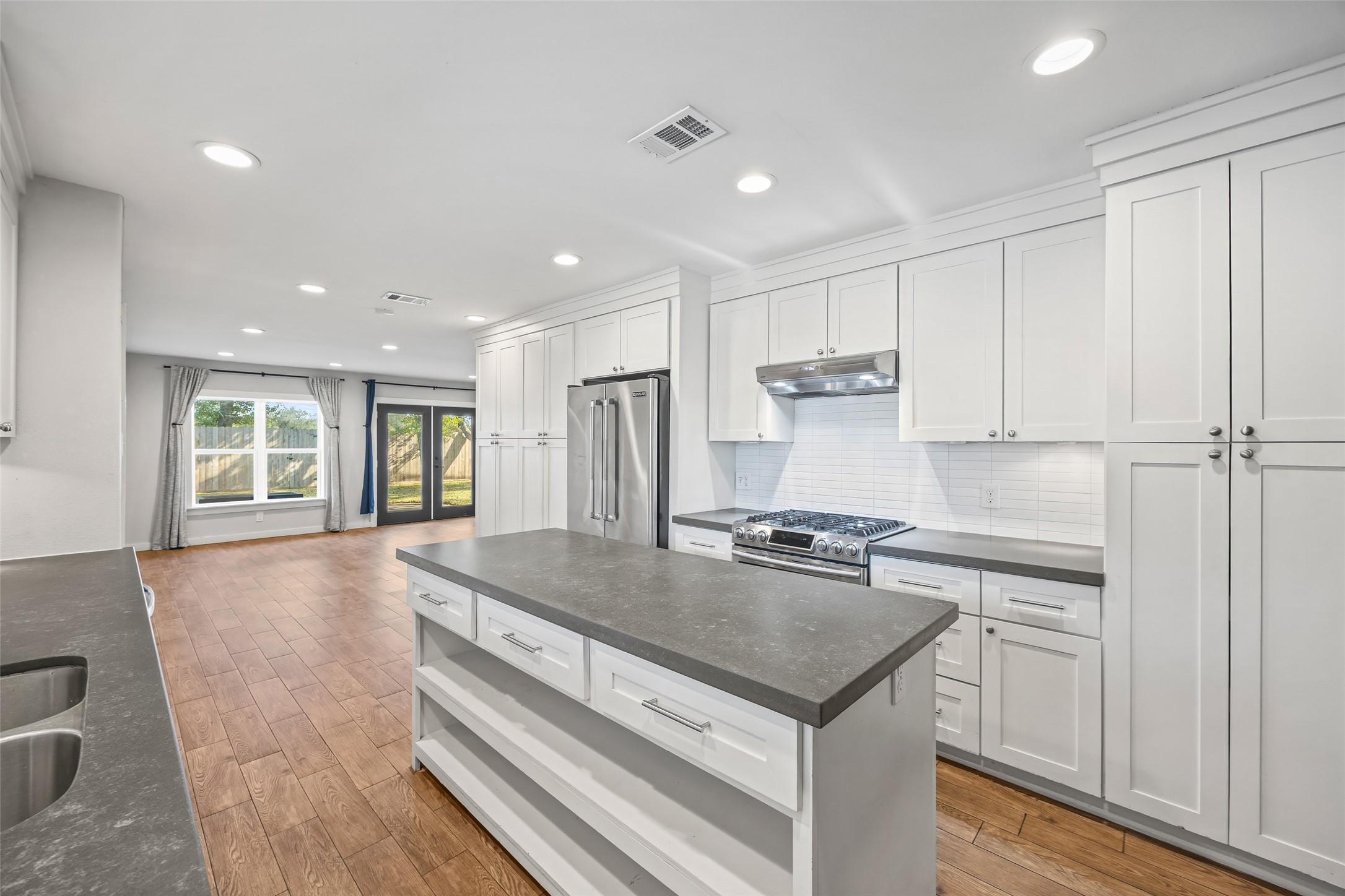 9715 Greenwillow Street Houston, TX 77096 - Photo 8 of 31 a kitchen with a stove a sink and a refrigerator