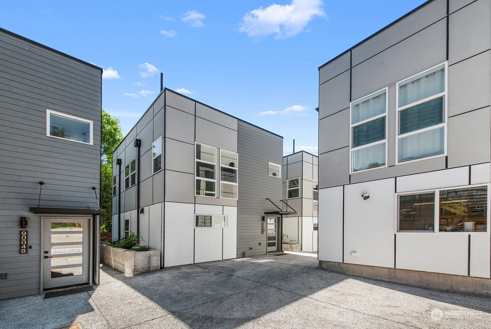 9004 15th Avenue Southwest, Unit A Seattle, WA 98106 - Photo 1 of 20 a view of a white building with many windows