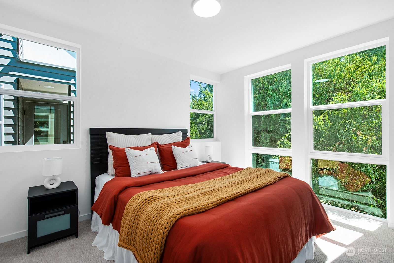 9004 15th Avenue Southwest, Unit A Seattle, WA 98106 - Photo 15 of 20 a bedroom with a bed and a large window