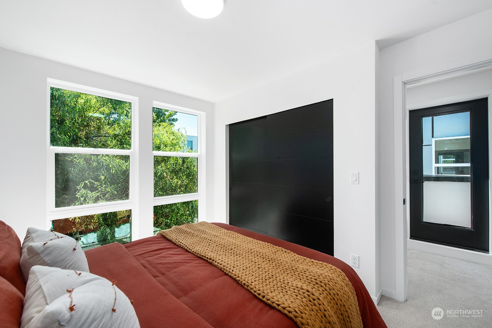 9004 15th Avenue Southwest, Unit A Seattle, WA 98106 - Photo 16 of 20 a bedroom with a bed and a large window