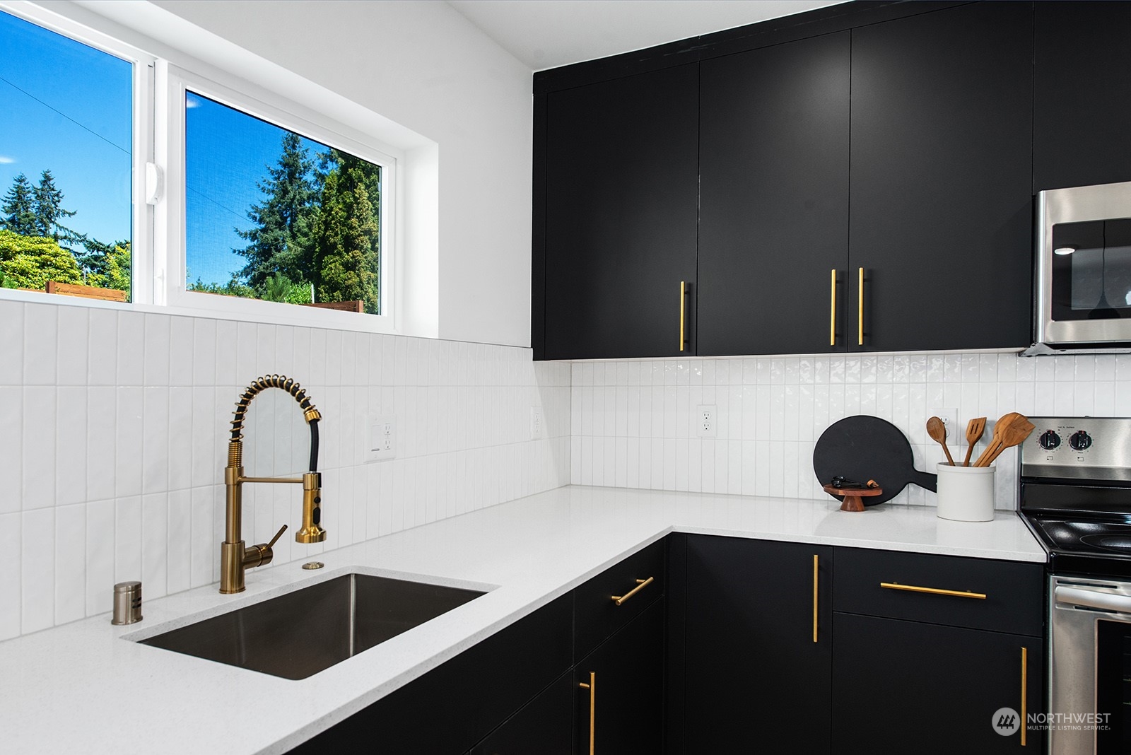 9004 15th Avenue Southwest, Unit A Seattle, WA 98106 - Photo 5 of 20 a sink with a microwave and cabinets