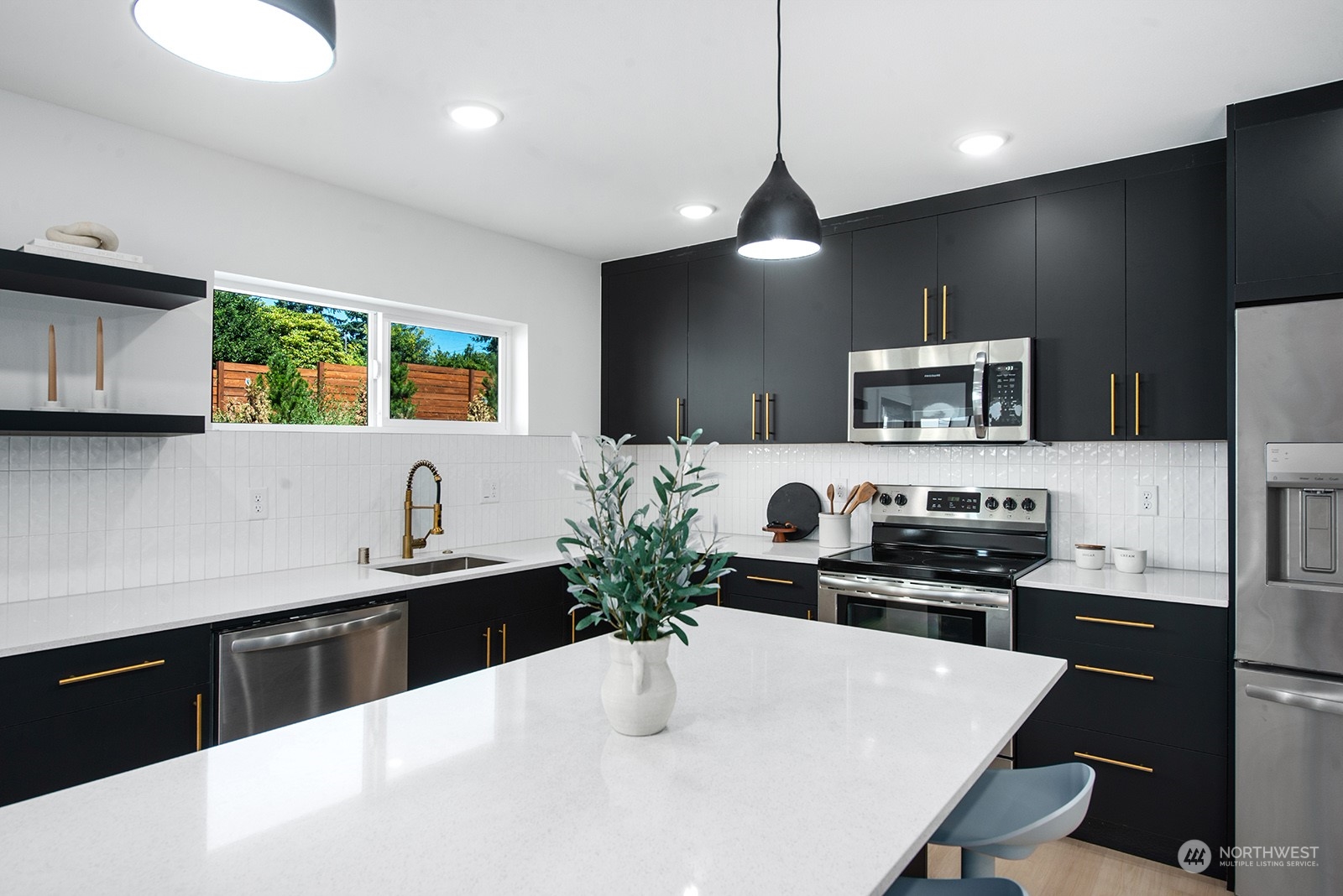 9004 15th Avenue Southwest, Unit A Seattle, WA 98106 - Photo 7 of 20 a kitchen with a sink a stove and chairs