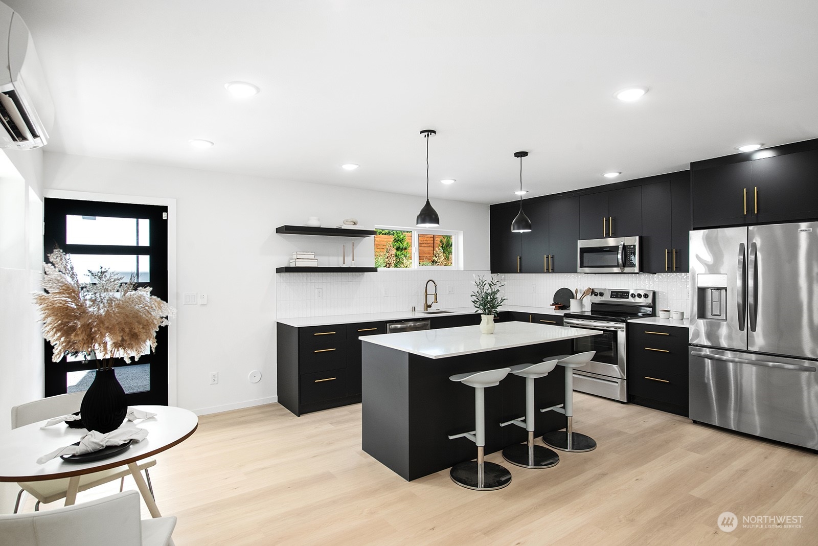 9004 15th Avenue Southwest, Unit A Seattle, WA 98106 - Photo 8 of 20 a kitchen with stainless steel appliances kitchen island granite countertop a stove refrigerator and cabinets