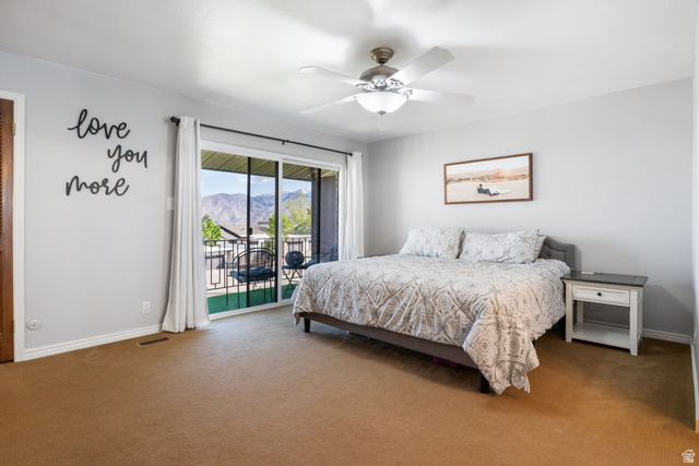 41 Benchmark Village Tooele, UT 84074 - Photo 10 of 26 Bedroom with access to outside, carpet, ceiling fan, and a mountain view