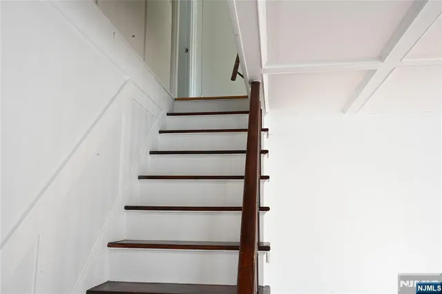 a view of staircase with white walls and a window