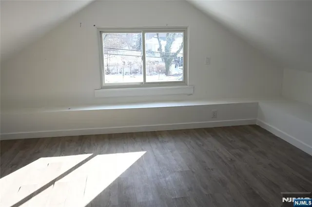 a bathroom with a bathtub and a window