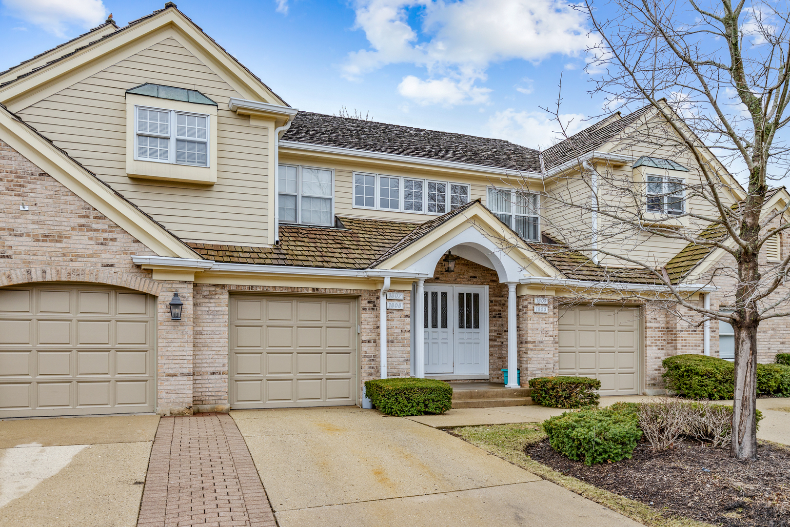 1805 Ashbury Lane, Unit 1805 Inverness, IL 60067 - Photo 1 of 21 a front view of a house with garden