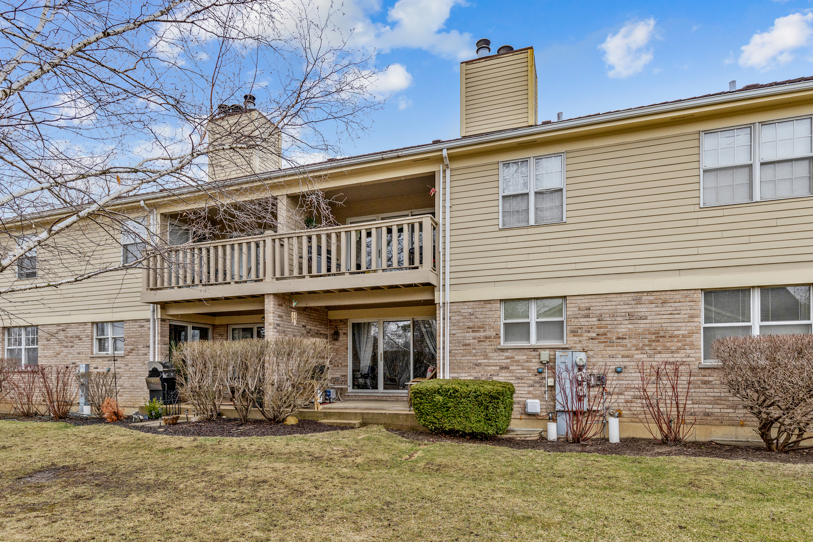 1805 Ashbury Lane, Unit 1805 Inverness, IL 60067 - Photo 20 of 21 a front view of a house with a yard balcony
