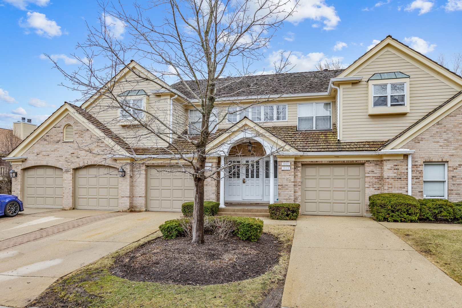 1805 Ashbury Lane, Unit 1805 Inverness, IL 60067 - Photo 2 of 21 a front view of a house with garden