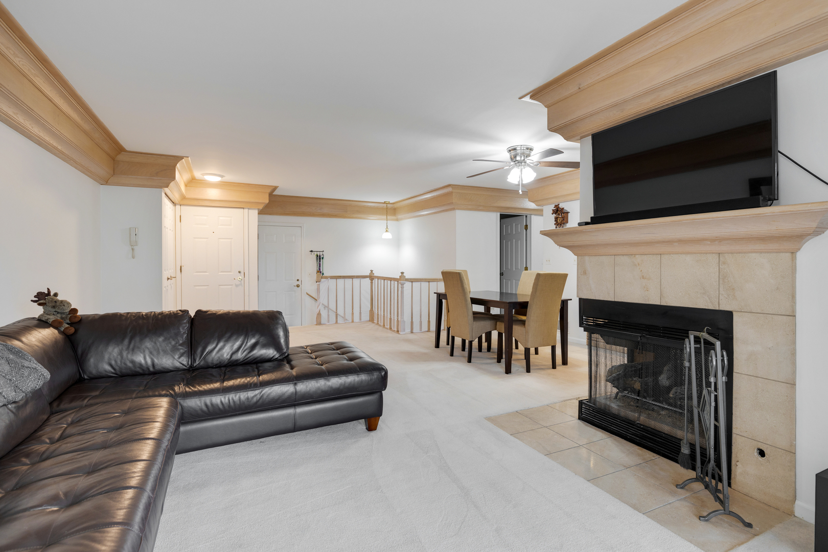 1805 Ashbury Lane, Unit 1805 Inverness, IL 60067 - Photo 9 of 21 a living room with furniture a fireplace and a flat screen tv
