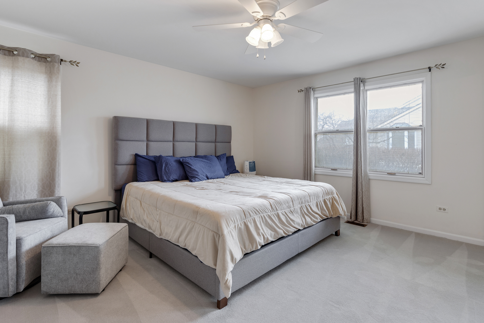 1805 Ashbury Lane, Unit 1805 Inverness, IL 60067 - Photo 10 of 21 a bedroom with a large bed and a chandelier