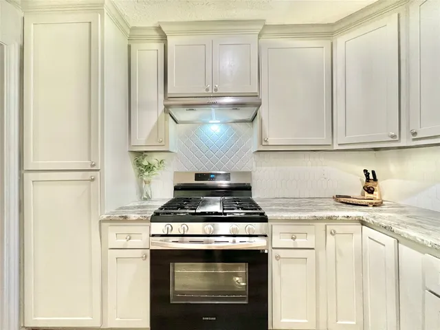 a kitchen with a stove and a refrigerator
