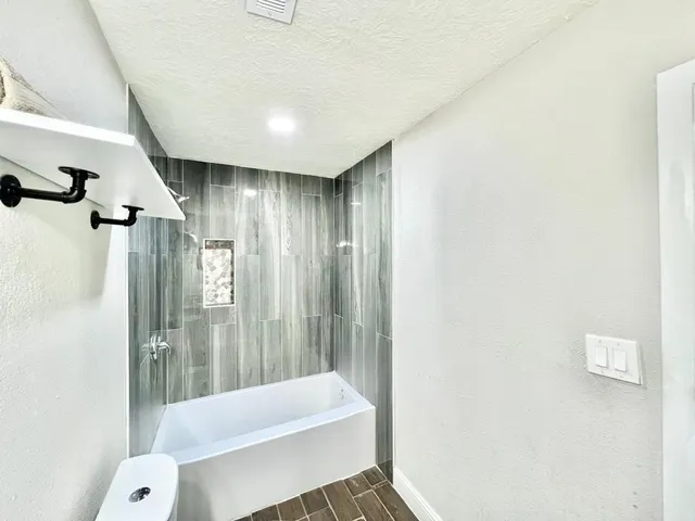 a bathroom with a shower and a toilet