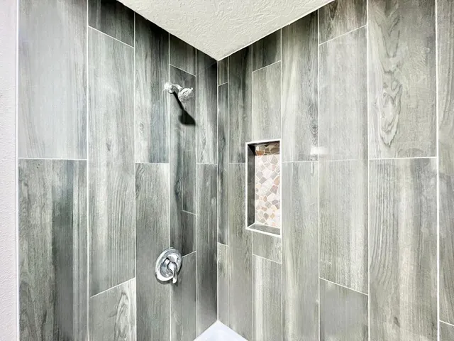a bathroom with a shower and a glass door