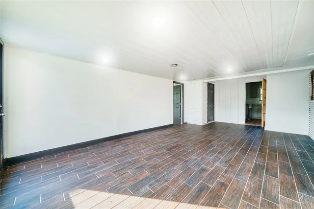 a view of an empty room and wooden floor