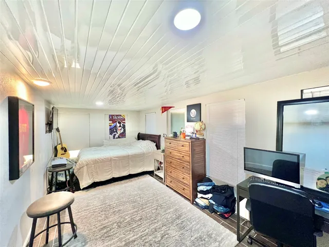 a bedroom with a bed and a desk