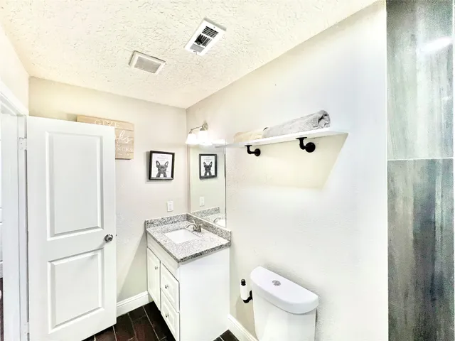 a bathroom with a sink a toilet and a mirror