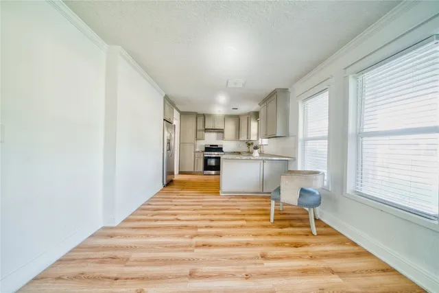 a view of kitchen with wooden floor and electronic appliances