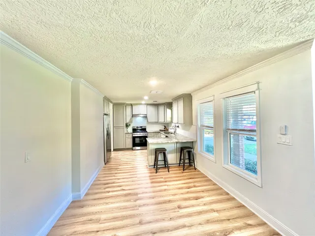 a view of a dining hall with furniture and wooden floor