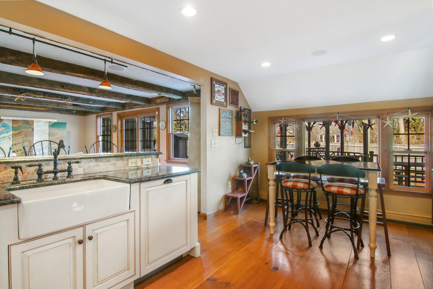 4 Shapquit Bars Road Falmouth, MA 02540 - Photo 12 of 45 a kitchen with stainless steel appliances granite countertop dining table chairs and wooden floor
