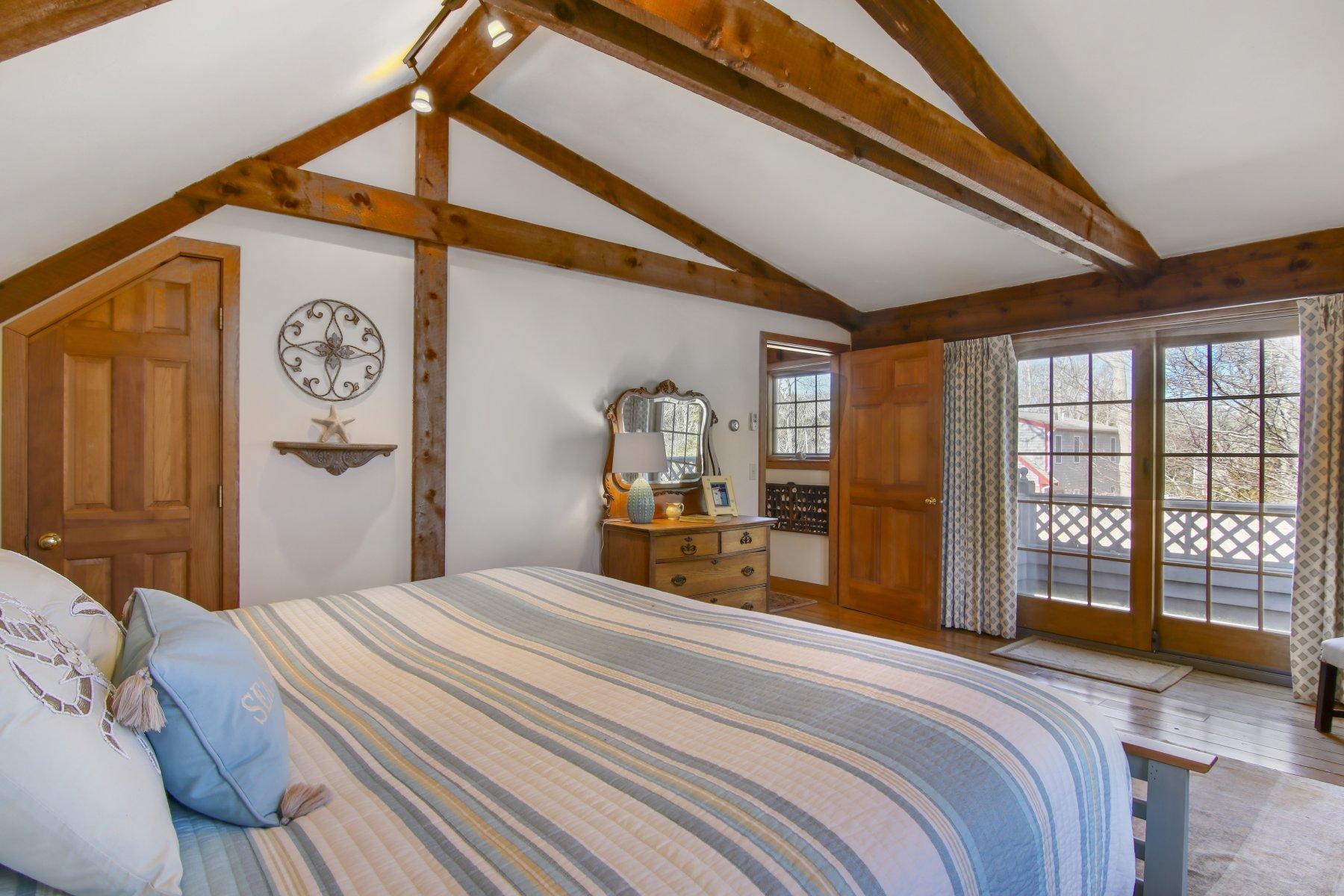 4 Shapquit Bars Road Falmouth, MA 02540 - Photo 17 of 45 a bedroom with a large bed and a large window