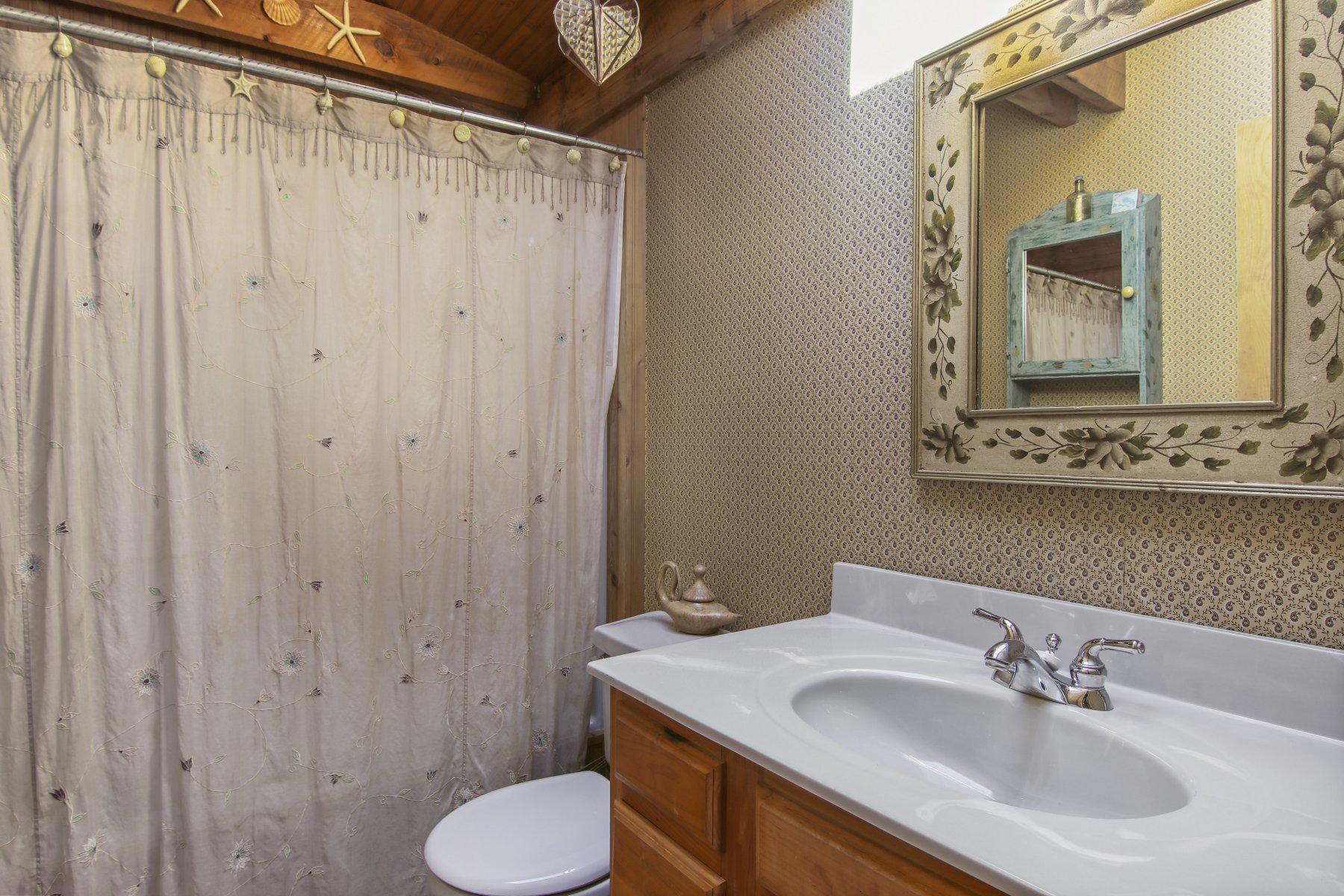 4 Shapquit Bars Road Falmouth, MA 02540 - Photo 20 of 45 a bathroom with a toilet sink and mirror