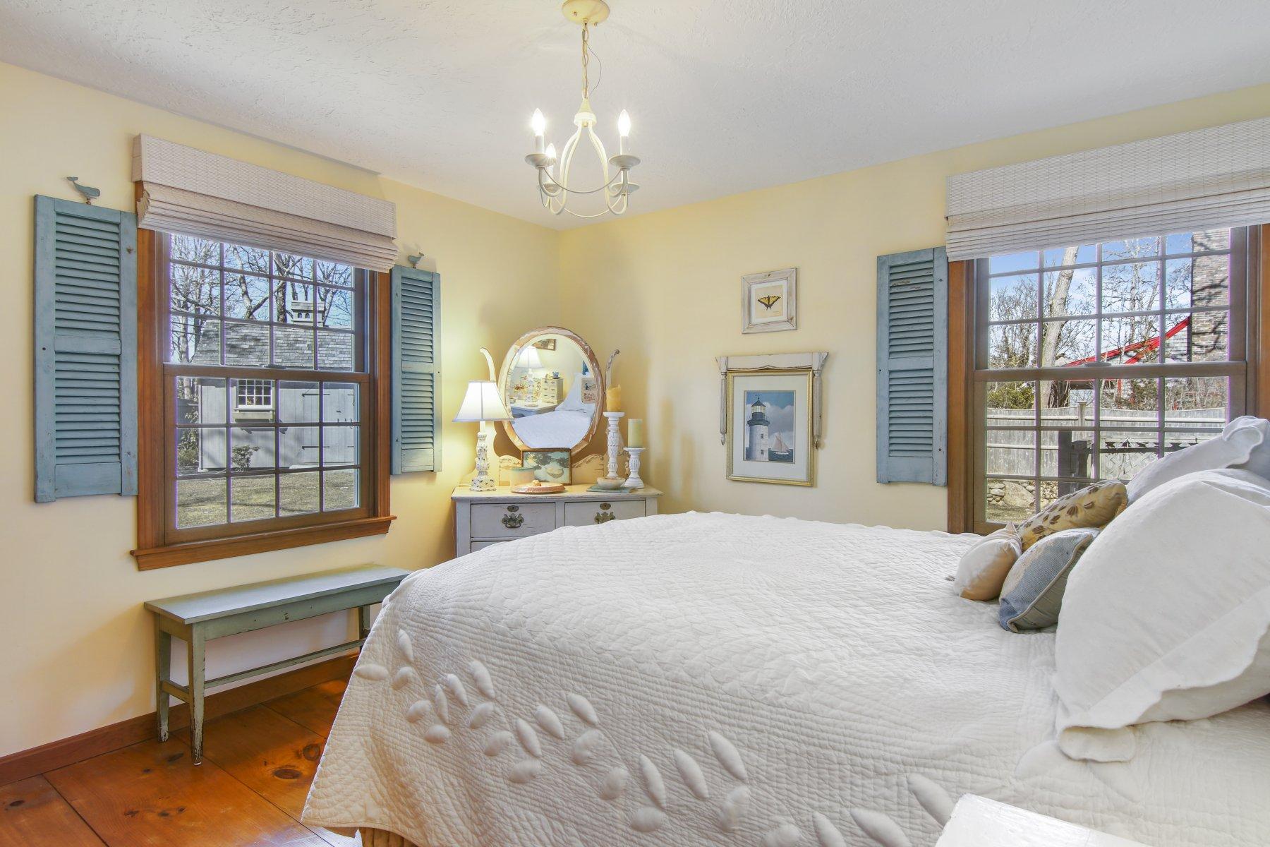 4 Shapquit Bars Road Falmouth, MA 02540 - Photo 21 of 45 a bed sitting in a bedroom next to a window