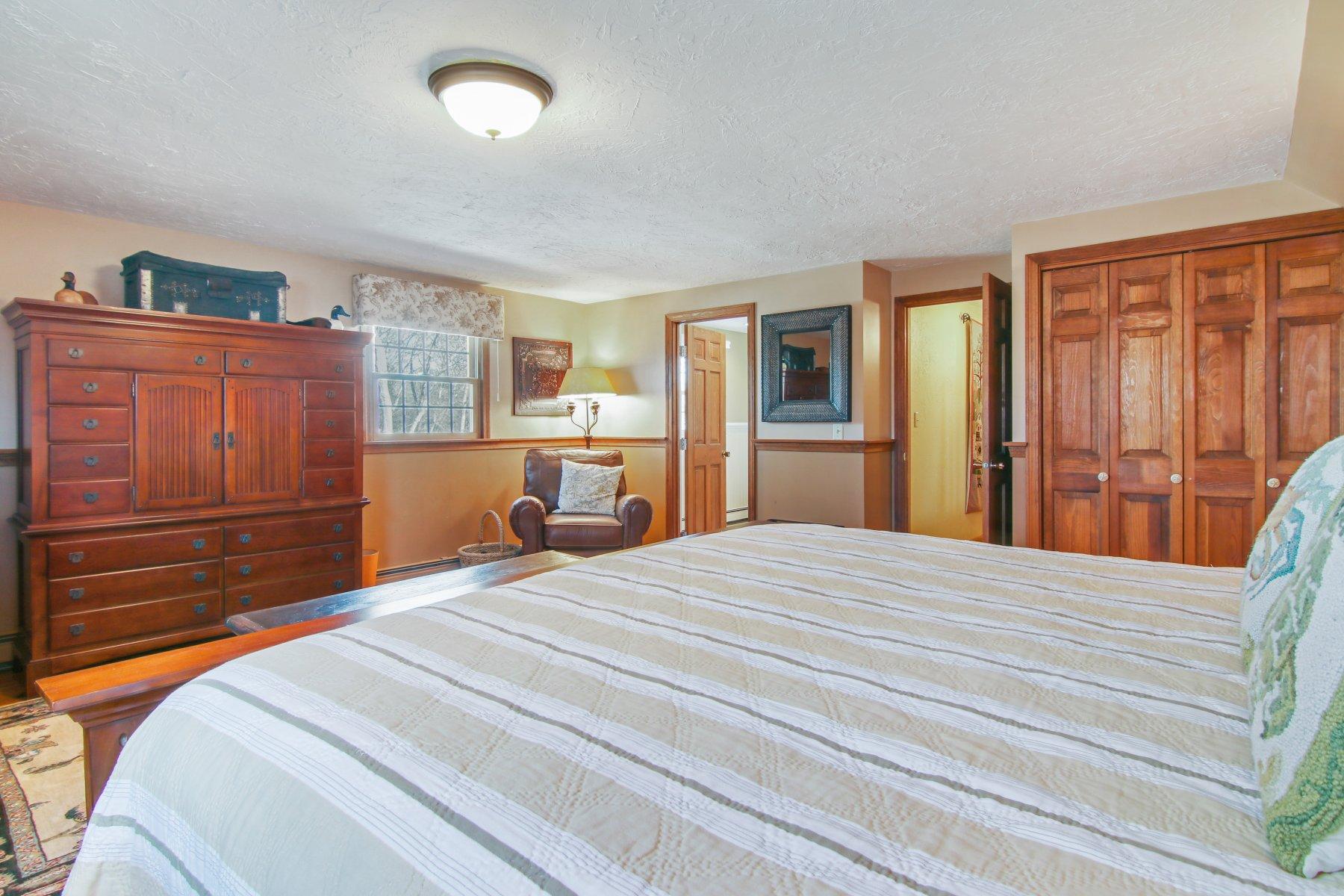 4 Shapquit Bars Road Falmouth, MA 02540 - Photo 24 of 45 a bedroom with a bed and wooden floor