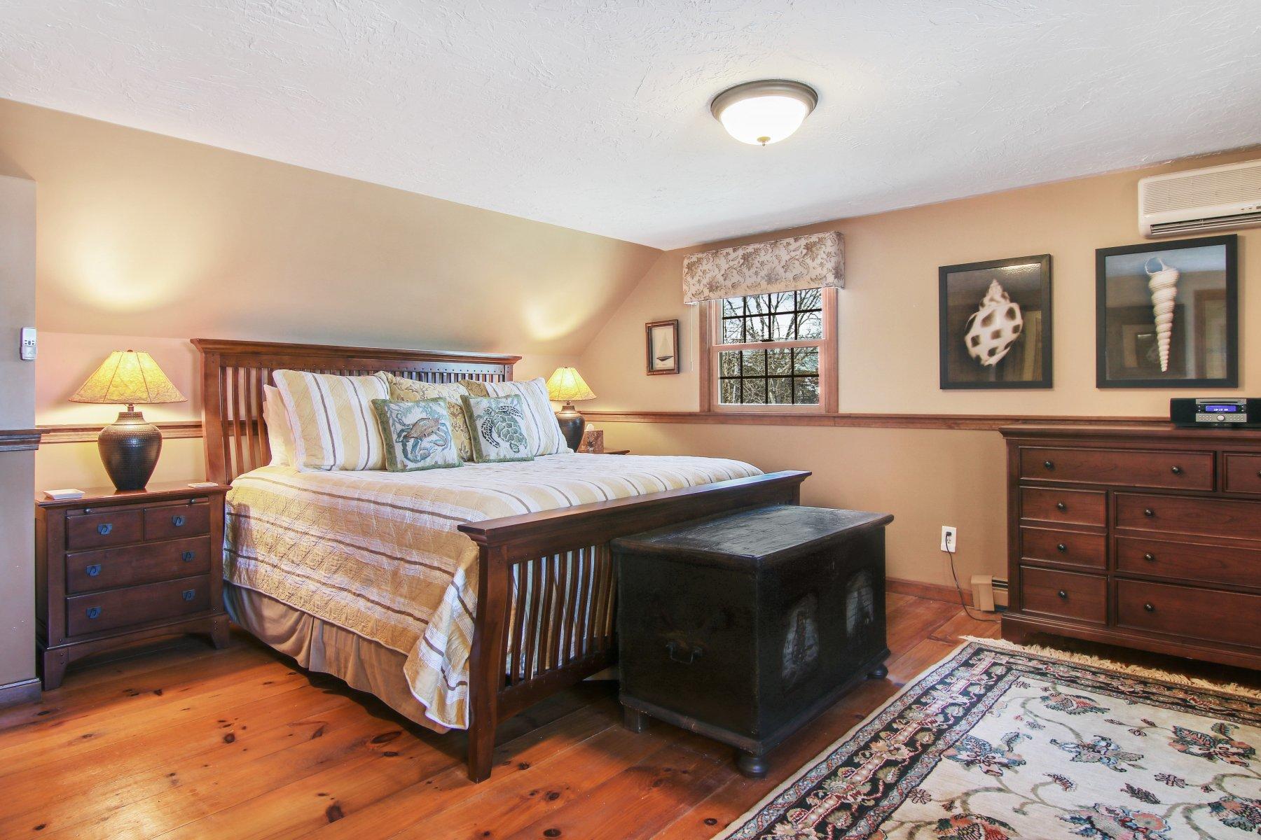 4 Shapquit Bars Road Falmouth, MA 02540 - Photo 26 of 45 a bedroom with a bed and wooden floor