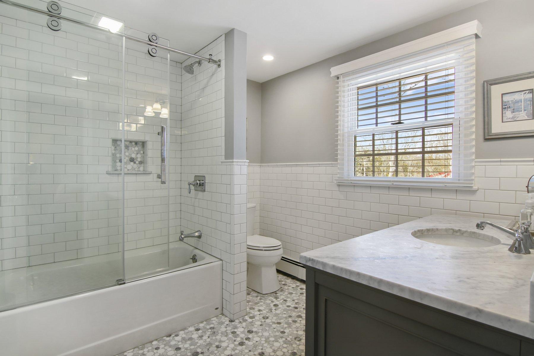 4 Shapquit Bars Road Falmouth, MA 02540 - Photo 28 of 45 a bathroom with a sink a toilet and shower