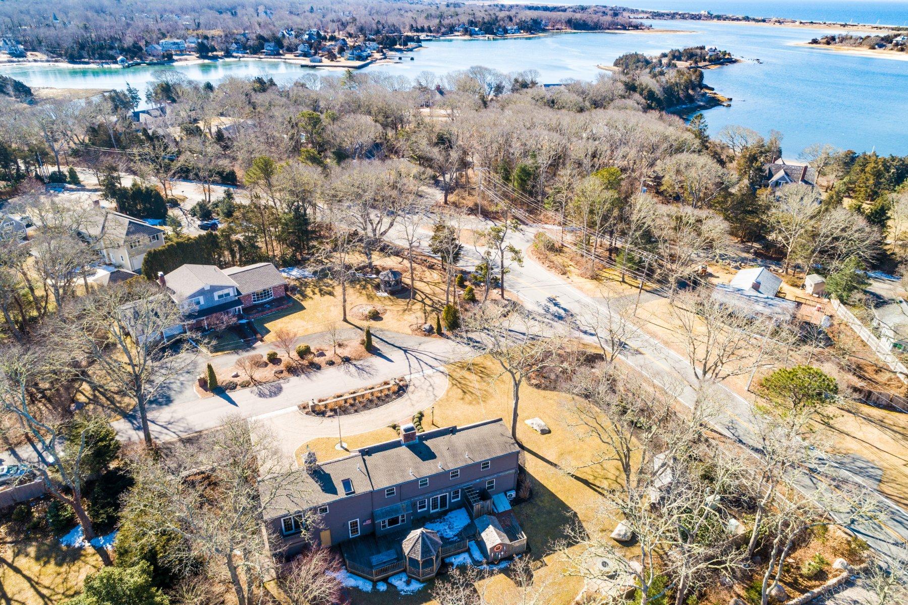 4 Shapquit Bars Road Falmouth, MA 02540 - Photo 35 of 45 an aerial view of a house with a yard and large trees