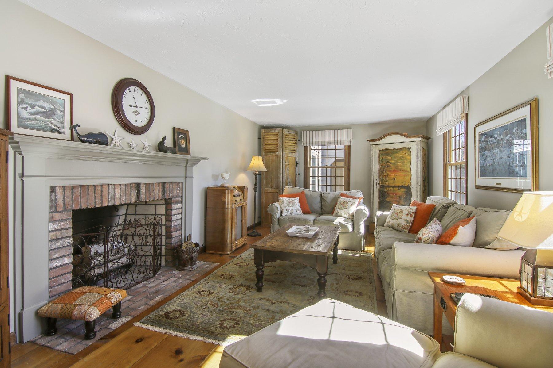 4 Shapquit Bars Road Falmouth, MA 02540 - Photo 6 of 45 a living room with furniture a fireplace and a large window
