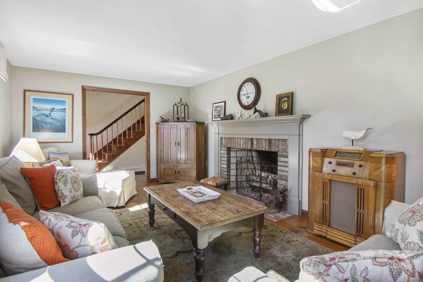 4 Shapquit Bars Road Falmouth, MA 02540 - Photo 7 of 45 a living room with furniture and a fireplace